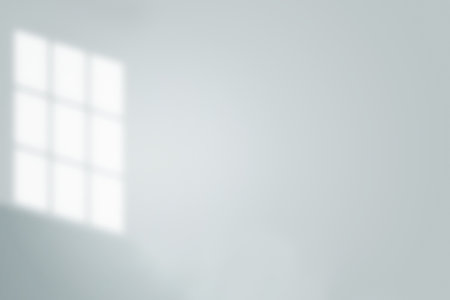 Illuminated lines: a play of sunlight and shadows falling from a window onto a light wall.の写真素材