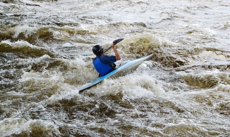 River Vuoksi, Leningrad Region, Russia - 3 July 2011: Kayaker sporting a kayak cuts through water.のeditorial素材