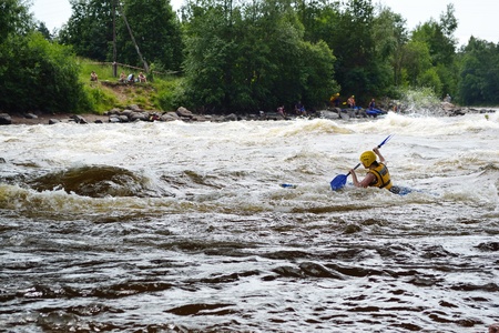 River Vuoksi, Leningrad Region, Russia - 3 July 2011: Kayaker sporting a kayak cuts through water.のeditorial素材