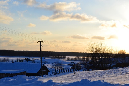 View of snowy russian village at sunsetの写真素材
