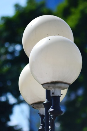 Street round lamp in the city park on blue sky backgroundの写真素材