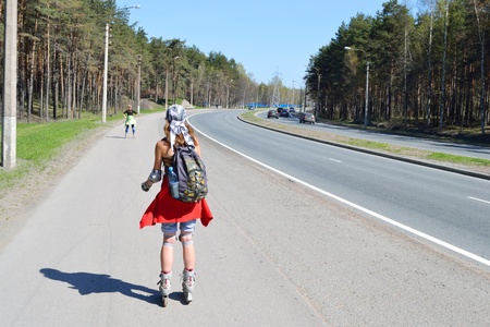 St.Petersburg, Russia - May 15, 2011: Girl rides a roller along the roadside