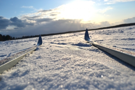 Frozen lake and skiing at sunny winter day, Leningrad region, Russia.