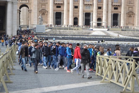 Vatican city, Vatican - February 20, 2014: Tourists in St Peter's Square. Saint Peter's Square is among most popular pilgrimage sites for Roman Catholics.のeditorial素材
