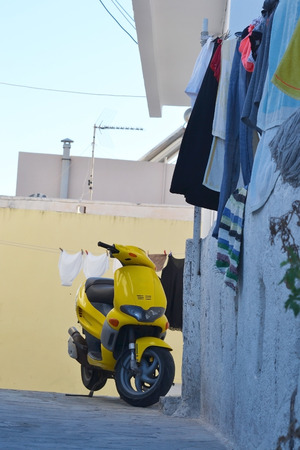 Yellow scooter on street of Kefalos on a Greek island of Kos, Greece.の写真素材