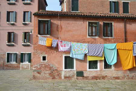 VENICE, ITALY - FEBRUARY 18, 2014: Clothes hanging to dry in a small street in Venice, Italy.のeditorial素材