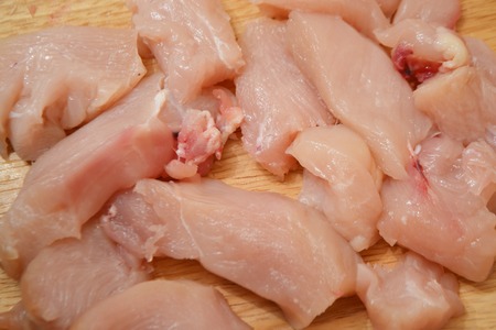 Raw chicken fillet on a wooden board.の写真素材