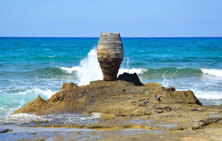 Rocks and decorative vase on the Aegean coast in Malia, Crete, Greece.の写真素材