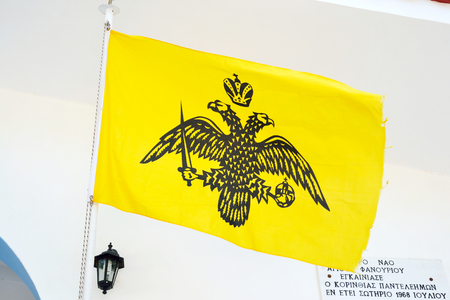 LOUTRAKI, GREECE - 1 JUNE, 2015: Flag of the Byzantine Empire, Eastern roman empire. Near the Orthodox church in the city of Loutraki.のeditorial素材