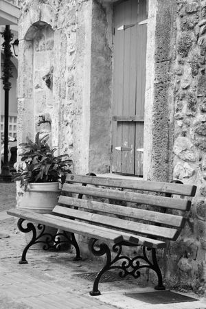 Bench on the street in the old part of Malia on Crete island, Greece. Black and white.の写真素材