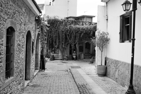 MALIA, GREECE - 11 SEPTEMBER, 2015: Street in old part of Malia. Malia tourist town on the northern coast of Crete. Black and white.のeditorial素材