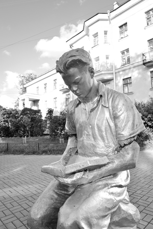 ST.PETERSBURG, RUSSIA - 16 JULY 2016: Sculpture - a young man reading a book, town Metallostroy, outskirts of St. Petersburg, Russia. Black and white.のeditorial素材