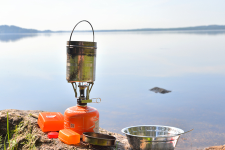 KAVGOLOGO, RUSSIA - 21 AUGUST 2016: Tourist gas burner against the background of lake.のeditorial素材