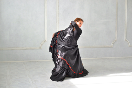 ST.PETERSBURG, RUSSIA - 27 MARCH 2017: Woman in a black dress is dancing flamenco in a bright studio. Project Dancing Petersburg.のeditorial素材