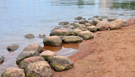 Granite stones on coast of Neva River, Russia.の写真素材