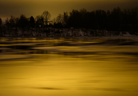 View of Neva River at evening when the clouds reflected the light from the city lights on the outskirts of St. Petersburg, Russia.の写真素材