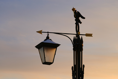 Street lamp in the old style on sunset sky background in St.Petersburg, Russia.の写真素材