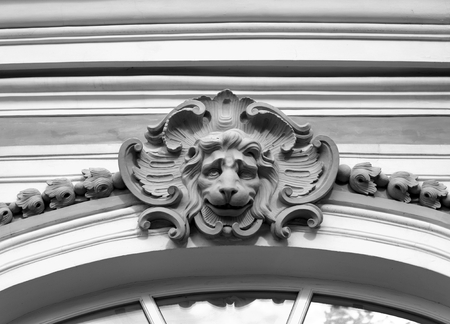 Old bas-relief with the head of a lion in Saint Petersburg, Russia. Black and white.の写真素材