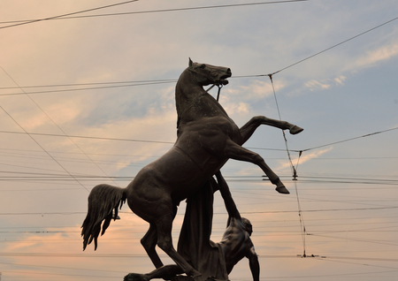 Statue of the conquest of a horse on the Anichkov Bridge at sunset, Saint Petersburg, Russia.の写真素材