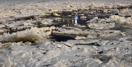 Ice on the water in the winter night.