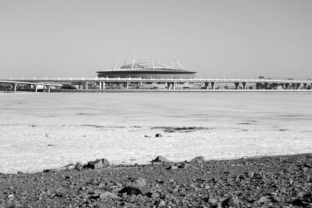 ST.PETERSBURG, RUSSIA - 3 APRIL 2019: Frozen Gulf of Finland of Baltic Sea and new Stadium Gazprom Arena at sunny day. Black and white.のeditorial素材