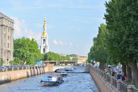 ST.PETERSBURG, RUSSIA - 8 JUNE 2019: Pleasure boat on Kryukov channel and Belltower of St. Nicholas Naval Cathedral in St. Petersburg.のeditorial素材