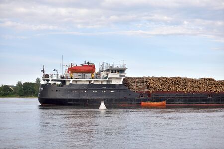 ST.PETERSBURG, RUSSIA - 13 JUNE 2019: Cargo ship on the Neva river on outskirts of St.Petersburg at...