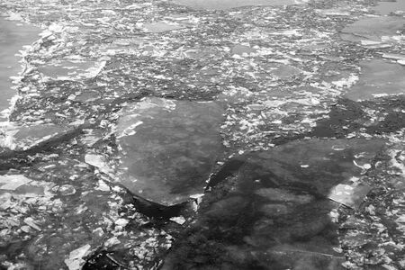Ice on river at cloud day, can be used as a background. Black and white.