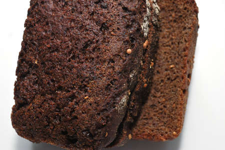 Black fresh sliced bread close up on white background.