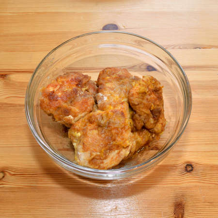 Ready-made breaded chicken fillet on plate on wooden background.の写真素材