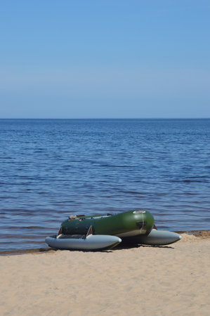 Rubber boat on the lake shore by summer day.の写真素材