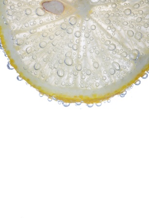 segment of lemon isolated on white with bulbes of waterの写真素材