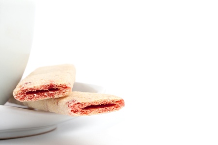 Cup of tea with cookie closeup isolated on white