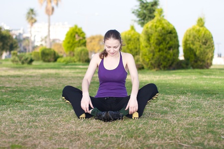 Woman in sports wear doing relaxing excercises