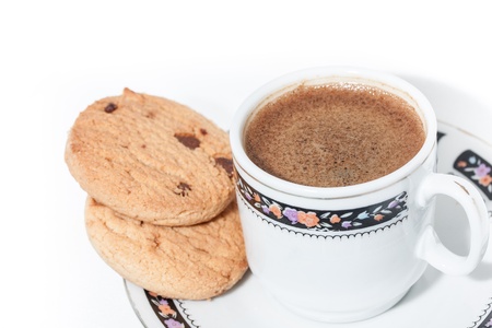 A cup of turkish coffe with froth and some cookies isolated on whiteの写真素材