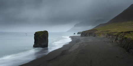 Typical Icelandic seascape with black basalt sand. Dramatic summer evening on the west coast of...