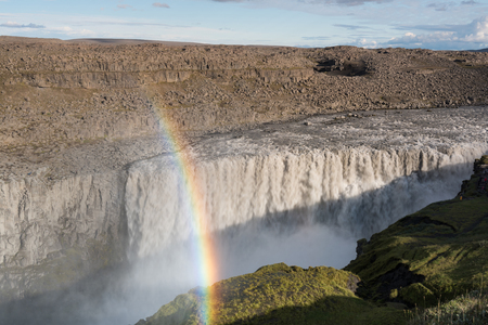 The most powerful waterfall in Europe - majestic Dettifoss in Iceland with a beautiful rainbow