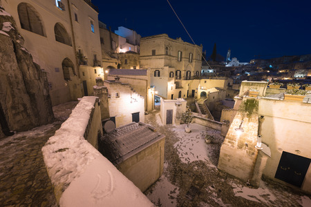 Night shot of Matera, Basilicata, Italy: picturesque ancient streets in the old town called Sassi di...