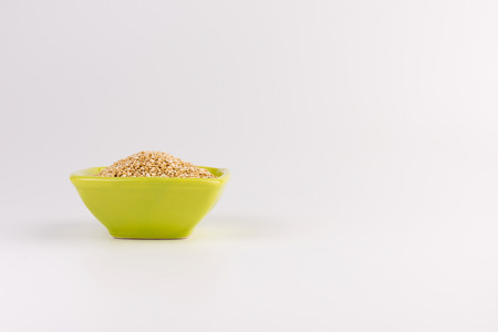 Quinoa in ceramic cup isolated on white background. Raw white quinoaの写真素材