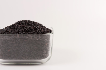 bowl of black wild rice isolated on white backgroundの写真素材