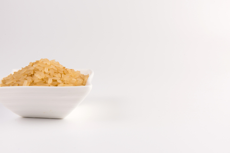 white rice in bowl isolated on white backgroundの写真素材