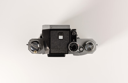 An old film camera is isolated on a white background