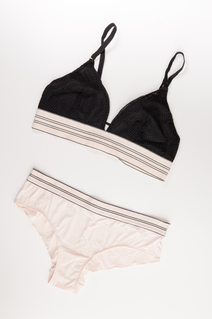 black bra and beige panties isolated on a white background, top viewの写真素材
