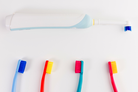 Red, pink, blue and light blue toothbrushes. Taking care of teeth, dental concept. Flat lay photo, copy space, top viewの写真素材