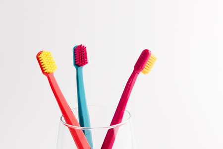 Cup with toothbrushes isolated on white background. Dental careの写真素材