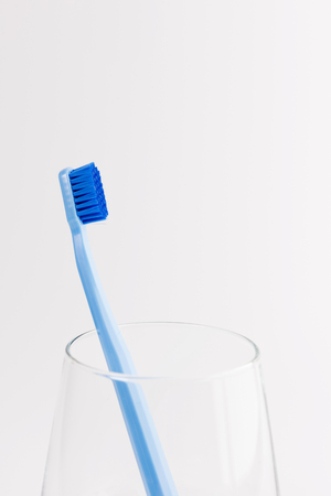 Cup with toothbrush isolated on white background. Dental careの写真素材
