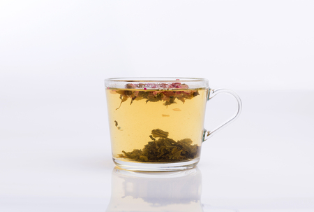 Glass cup of hot aromatic roses tea on white backgroundの写真素材