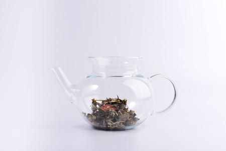Glass teapot with herbal tea isolated on white backgroundの写真素材