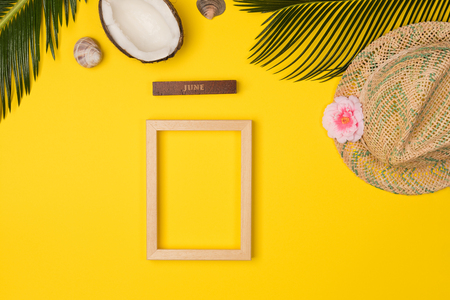 Summer vacation concept. hat, coconut and green palm leaves on blue background, flat lay. space for textの写真素材