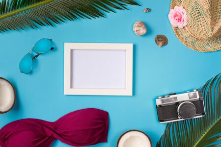Photo frame with beach accessories, on the blue background. Top view.の写真素材